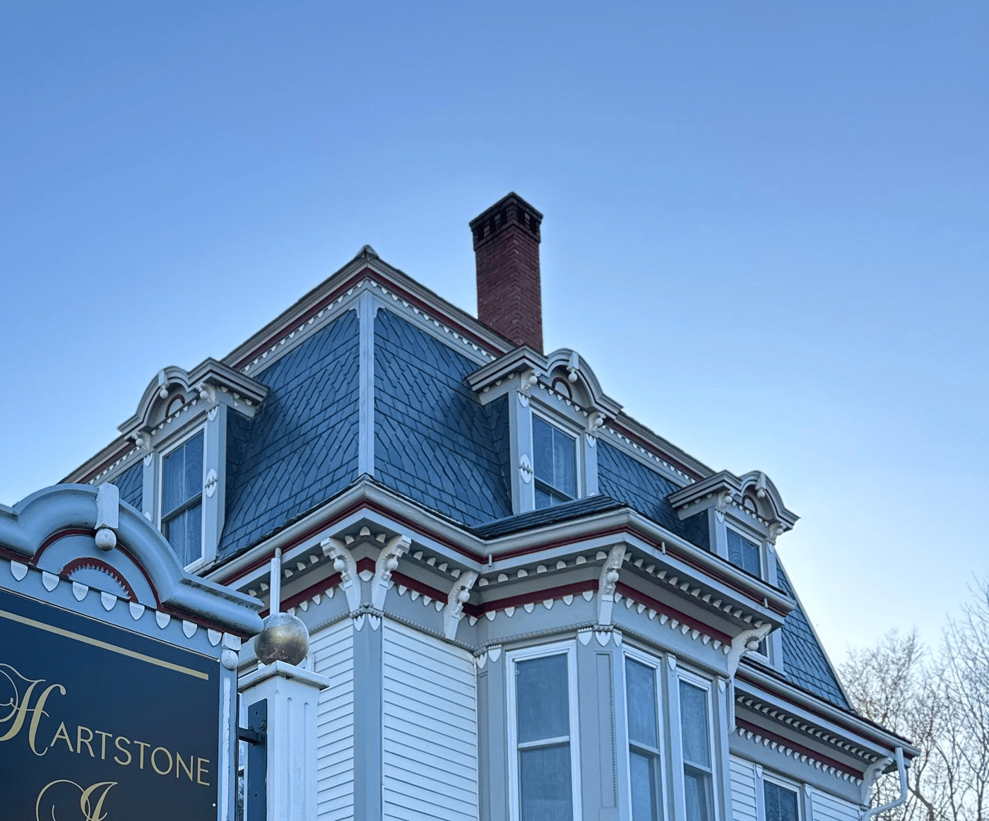 The mansard roof and bracketed cornices of the Hartstone Inn at dusk