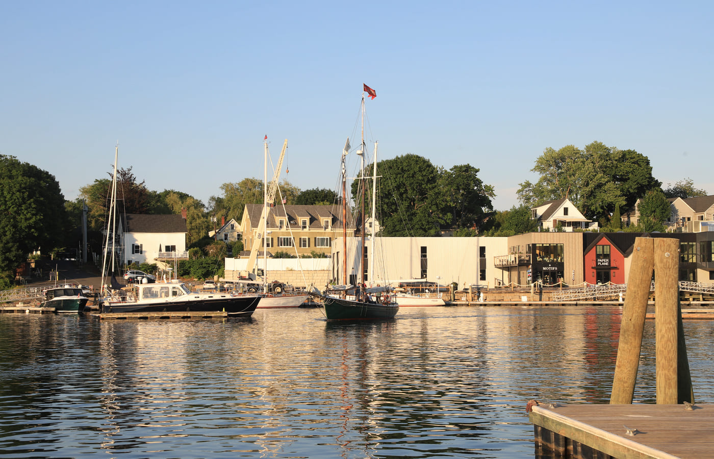 Schooners moored in Camden harbour in low evening light