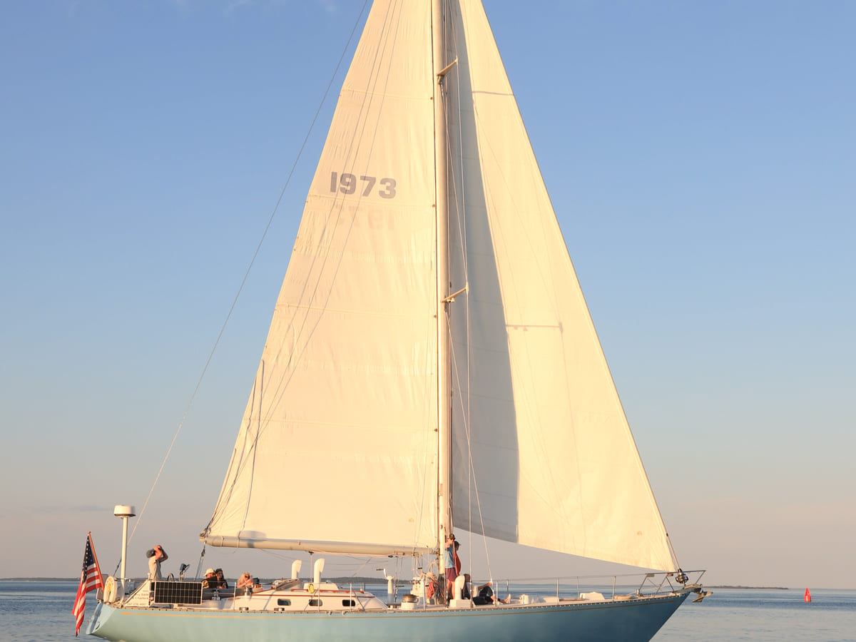 A schooner under full sail on Penobscot Bay at golden hour