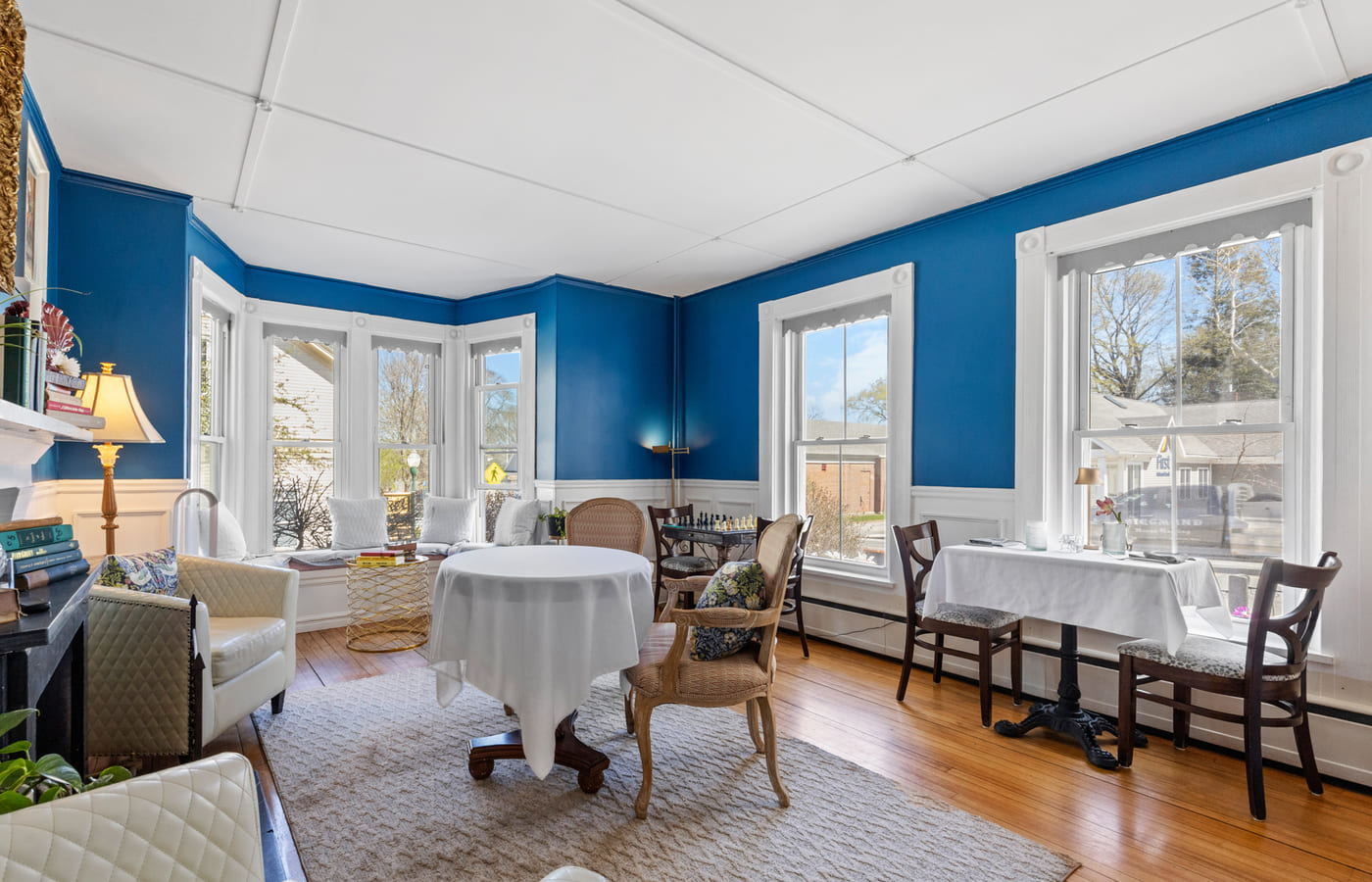 A wider view of the blue lounge set with linen tables and armchairs