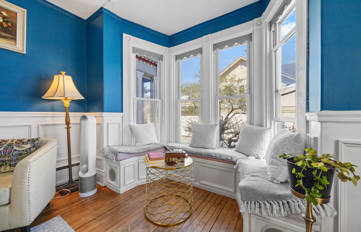 A cushioned window seat in the bay of the blue lounge