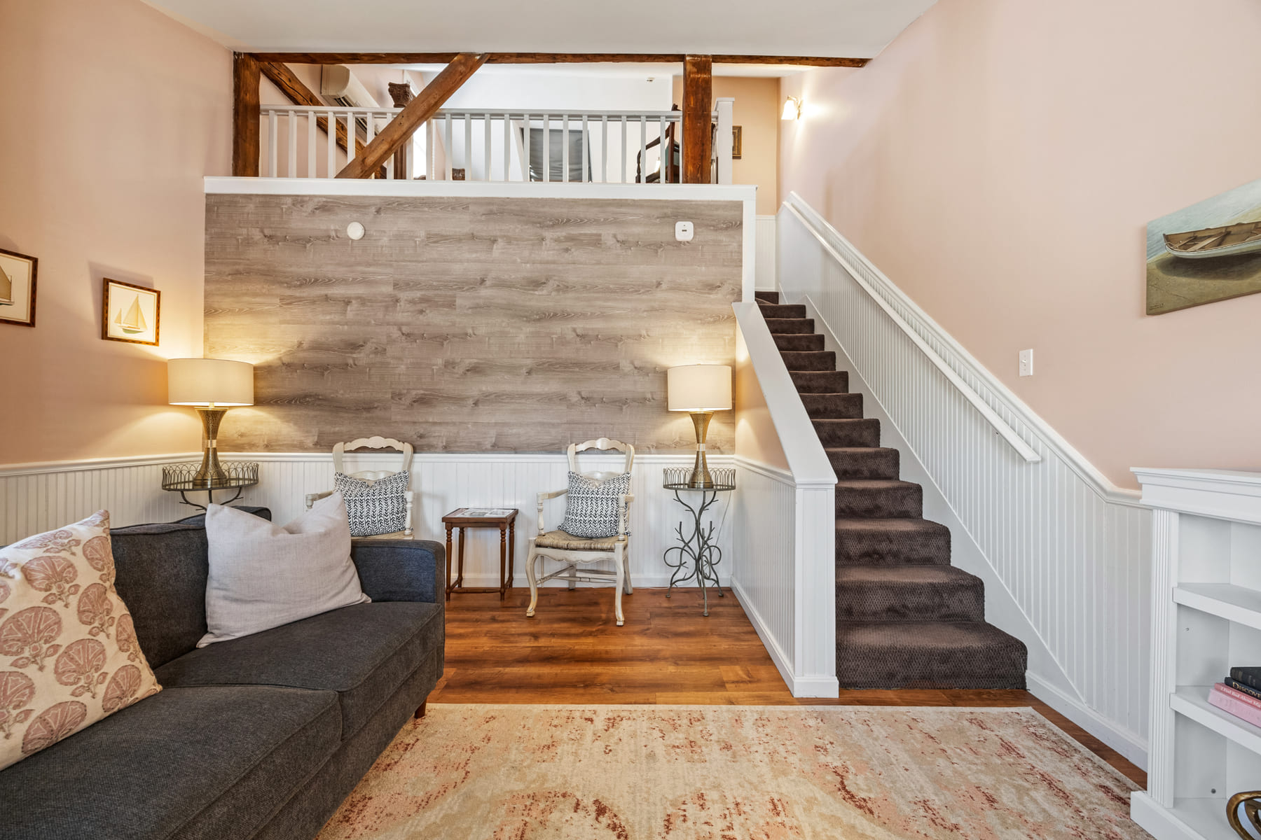 The two-level Normandy Suite with a sofa below and a railed sleeping loft above